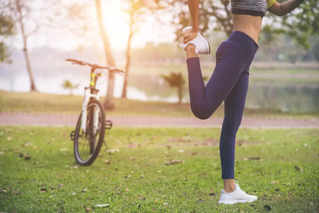 young woman, exercise in gardent background