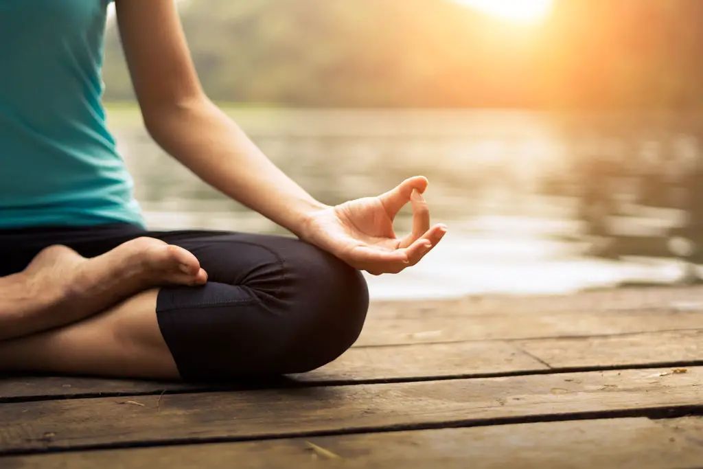 Woman exercising yoga at t