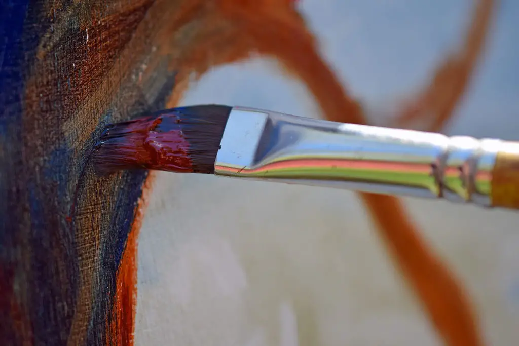 Close up of paint brush on canvas when artist painting with oil