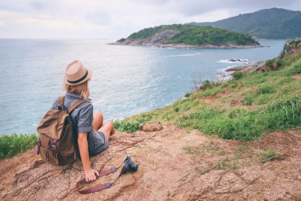 Young traveling woman with camera