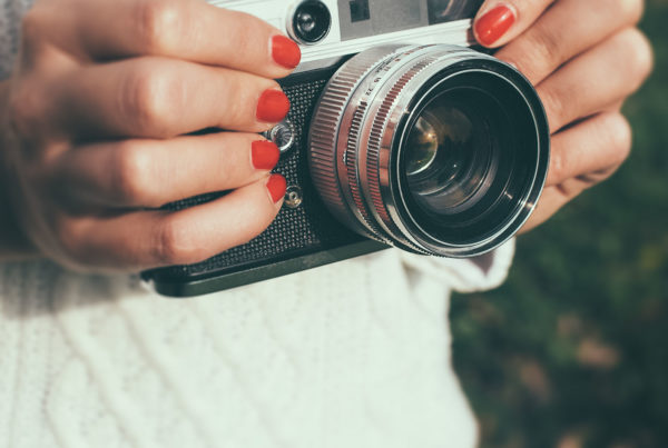 oung woman with a retro camera