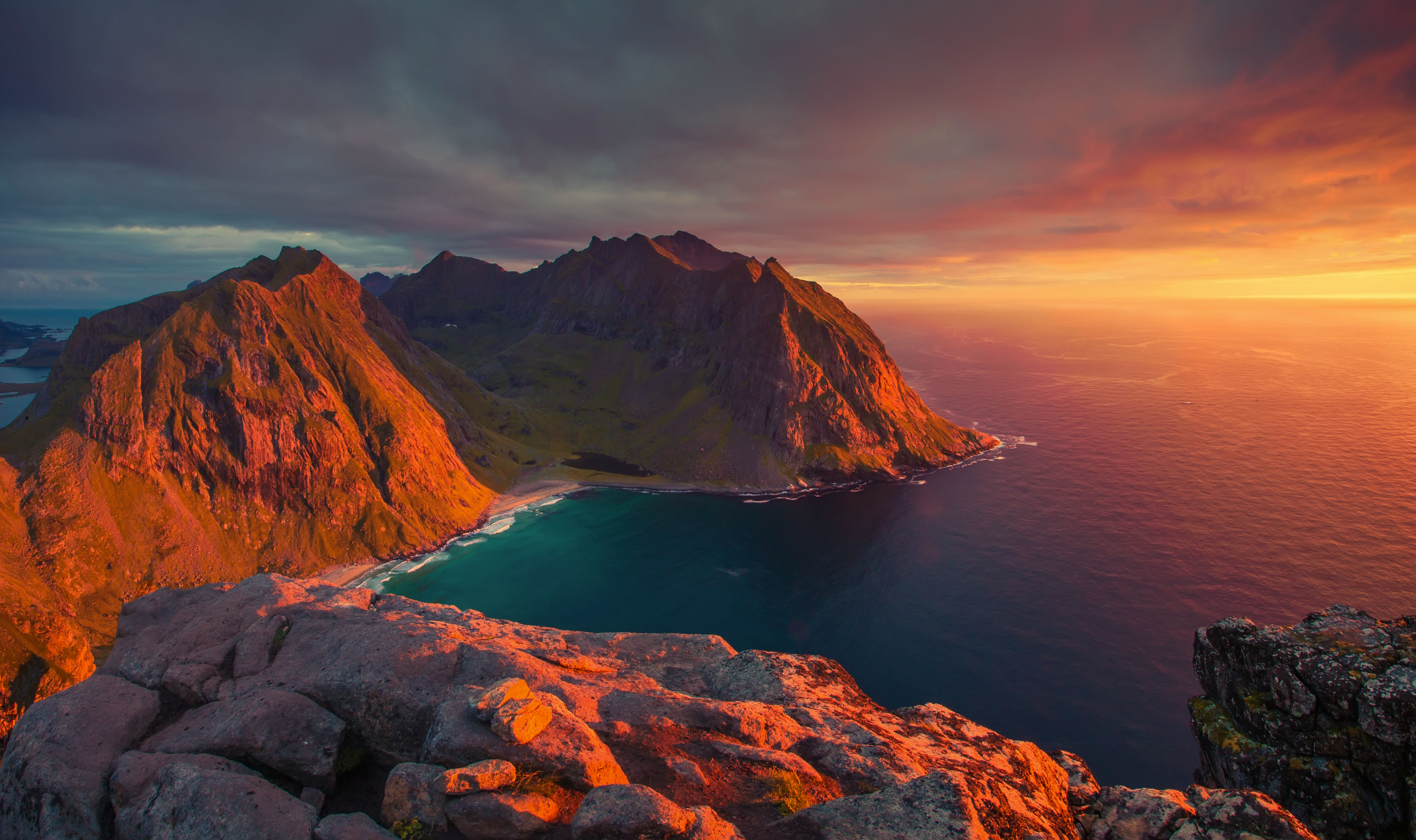 North sunset in Norway. Stunning sea view from mountains. Beautiful bay in evening sunlight. Lofoten islands landscape.